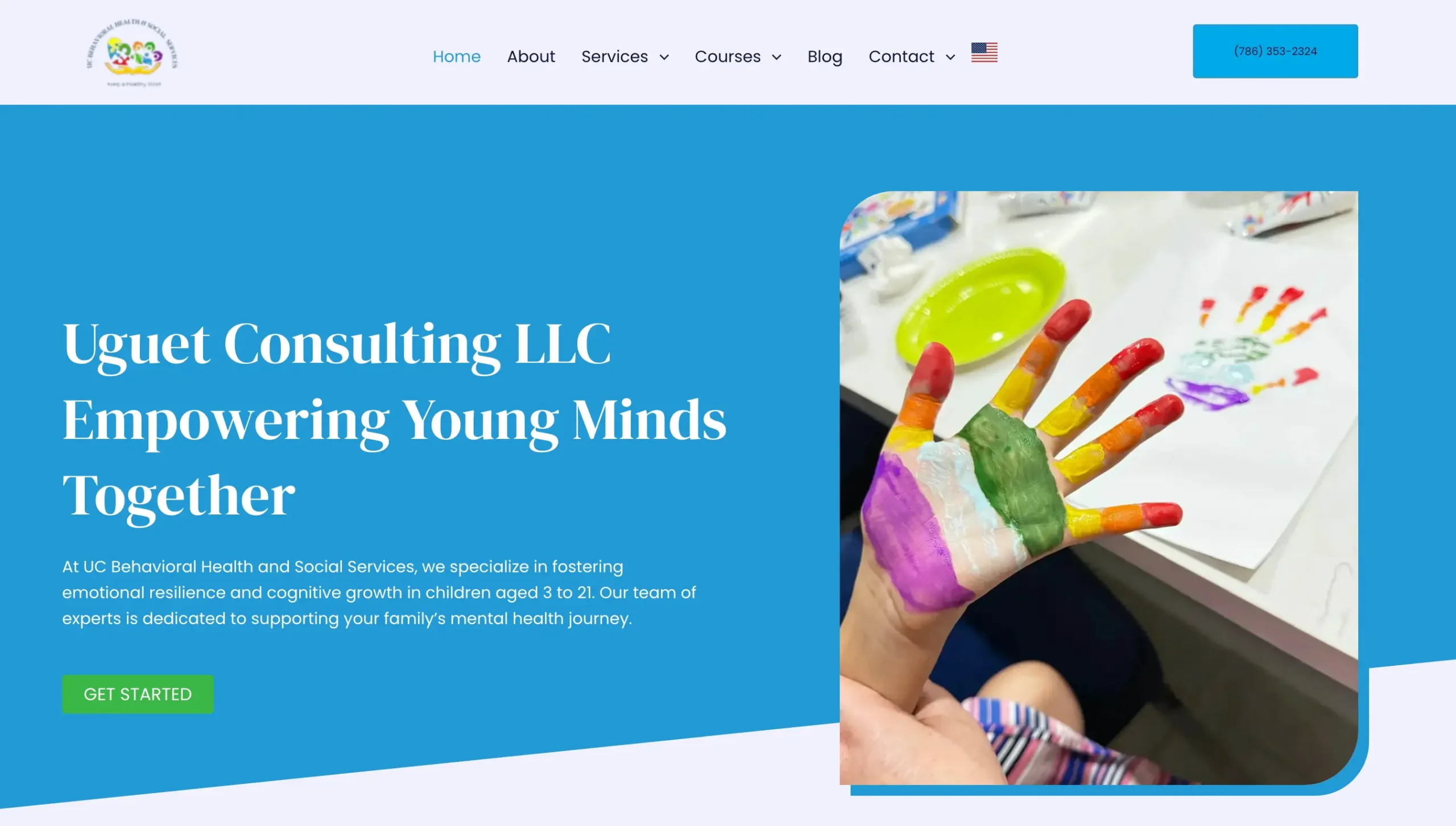 Captura de pantalla del sitio web de Uguet Consulting LLC con fondo azul y mano infantil pintada con los colores del arcoíris.